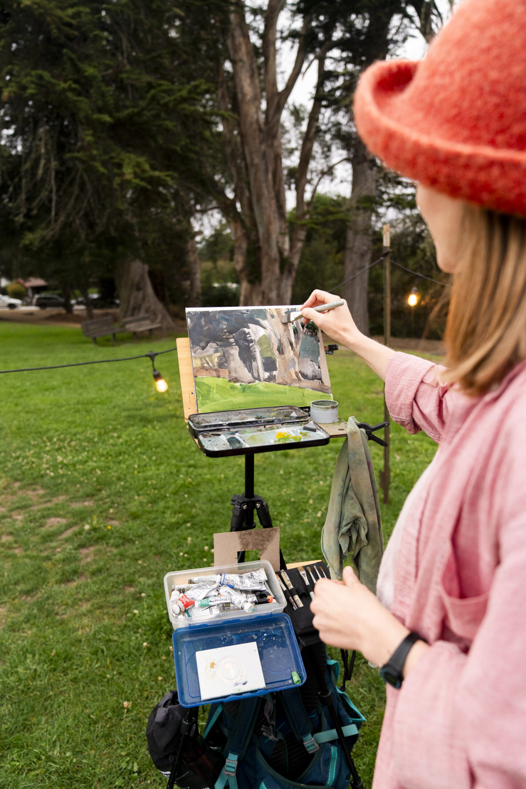 close up of a woman painting an outdoor scene