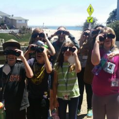 kids holding up binoculars