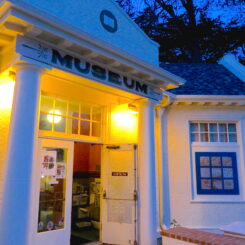 front of the museum during the evening with lights on