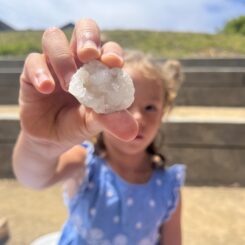 girl holding up a piece of geode