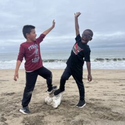 Two boys posing on a beach